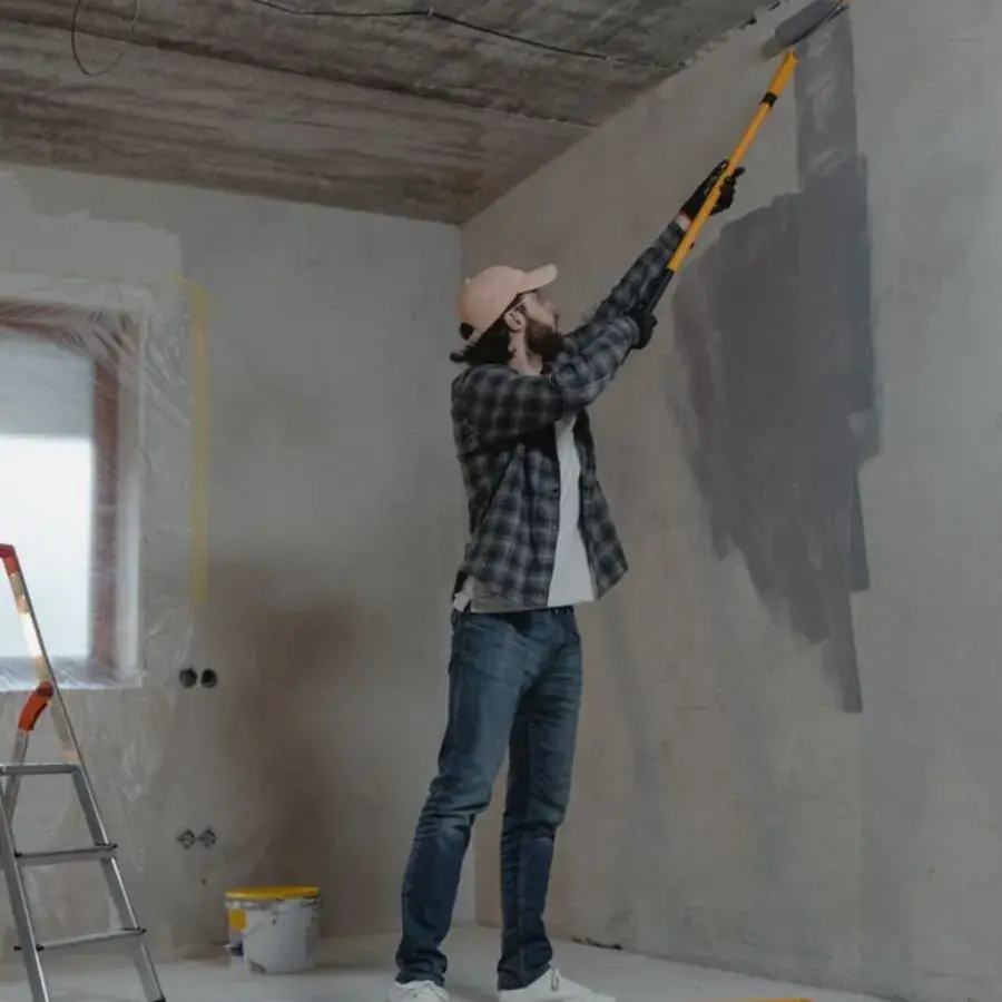 Painter using an extension roller to paint a wall and ceiling during a Perth renovation — Systemly builds automated quoting and booking systems for painting businesses