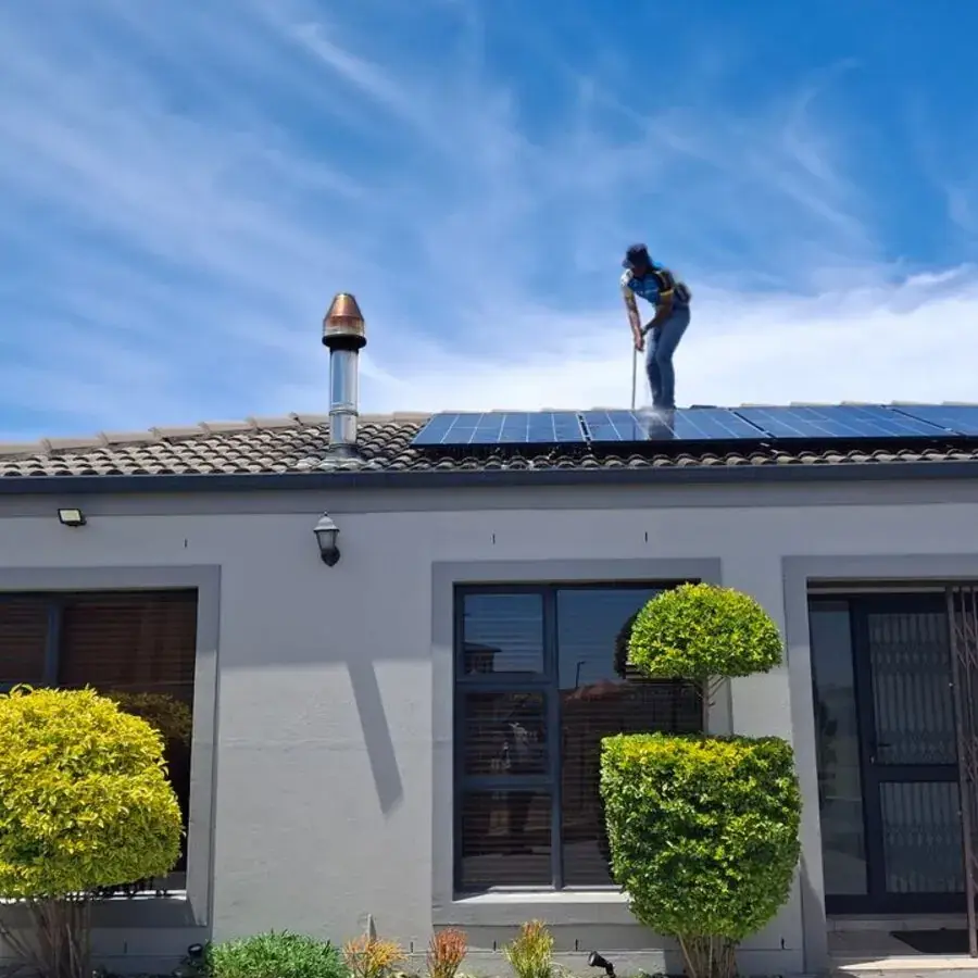 Solar installer working on rooftop panels under a bright blue sky in Perth — Systemly builds automated lead nurture and quoting systems for solar installation businesses